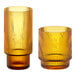 Two Acopa Lore amber glasses with a stripe pattern.