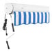 An Awntech Key West blue and white striped retractable awning with a cord.