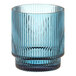 A blue ribbed glass tealight holder.