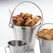 A group of American Metalcraft mini stainless steel pails with food in them.