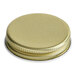 A close up of a 43/400 gold metal cap with a white plastisol liner.
