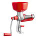 A red and silver Tre Spade manual tomato squeezer with plastic bowl.