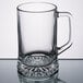 A clear glass Libbey beer mug with a handle.
