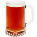 A Libbey glass beer mug filled with beer on a white background.