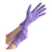 A person wearing purple Kimtech nitrile gloves.