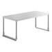An Avantco stainless steel rectangular table overshelf on a white rectangular table with metal legs.