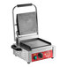 An Avantco commercial panini grill with smooth plates on a table in a professional kitchen.