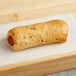 A Grand Prairie Cheddar Bagel Dog sandwich on a wooden tray.