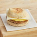 A Grand Prairie Turkey Sausage, Egg, and Cheese Muffin sandwich on a napkin.