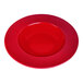 A close-up of a red Elite Global Solutions Maya melamine bowl with a rim.