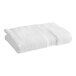 A folded white 1888 Mills Sweet South bath towel.