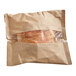 A brown bag with a Grand Prairie Smoky Bistro Chicken Sausage and Egg Brioche Sandwich inside.