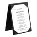 An Acopa Prime black 2-view table tent with a menu on a stand.