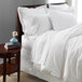 A white bed with a 1888 Mills Oasis white bed skirt.