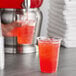 A hand pouring Gatorade Thirst Quencher Fruit Punch into a glass.