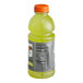 A close up of a Gatorade Lemon Lime sports drink bottle with green liquid inside.