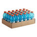 A cardboard box full of blue Gatorade bottles with red caps.