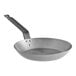 A Choice carbon steel frying pan with a handle.