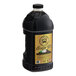A black plastic container of Lotus Plant Energy Naturally Sweetened Tea concentrate with a gold label.