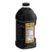 A large black bottle of Lotus Plant Energy Naturally Sweetened Tea concentrate with a yellow label.