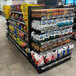 Wanzl Wire Tech double-sided add-on gondola shelving unit with snacks on the shelves in a store.