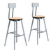 Two National Public Seating metal lab stools with Fusion Maple seats and backrests.