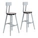 Two National Public Seating lab stools with gray seats and backs and metal frames.