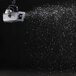 An Antari S-100X snow machine spraying snow on a black background.