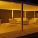A patio with Ape Labs Stick 2.0 LED lights above a table and chairs.