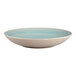 A white porcelain deep coupe plate with blue paint in a stripe design.
