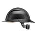 A Lift Safety Dax carbon fiber full brim hard hat with a black helmet and strap.