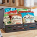 A basket of Miss Vickie's Kettle Potato Chip variety packs on a counter.