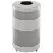 A round stainless steel Rubbermaid waste receptacle with holes in it.