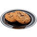 A black Fineline plastic plate with two cookies and silver bands.