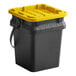 A black Tough Box 5 gallon bucket with a yellow lid.