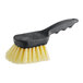 A Carlisle Sparta utility brush with a yellow handle and black bristles.