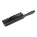 A close-up of a Carlisle black counter brush with bristles.