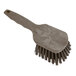 A close-up of a Carlisle Sparta brown pot scrub brush with a white background.
