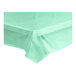 A mint green plastic tablecloth on a white background.