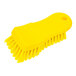 A yellow Carlisle Sparta handheld scrub brush with bristles and a handle.