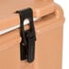 A brown plastic latch clip for a Cambro Camtainer.