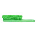 A close-up of a Carlisle Sparta lime green counter brush with bristles.