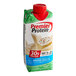 A case of 12 Premier Protein Cake Batter Delight protein shakes with a green and white carton and red label.