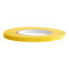 A roll of yellow tape with a white stripe.