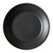 A black stoneware deep plate with a white rim.