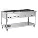 A Vollrath stainless steel commercial electric hot food table with four pans.