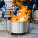A man and child roasting marshmallows over a BREEO stainless steel fire pit.