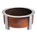 A BREEO Corten steel round metal fire pit on a table in an outdoor patio.