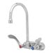 A silver T&S wall-mounted workboard faucet with gooseneck spout and wrist action handles.