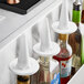 White Nite Cap dust covers on liquor bottles on a counter.